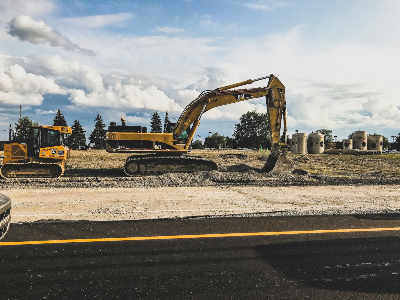 A yellow excavator digging earth on a construction site