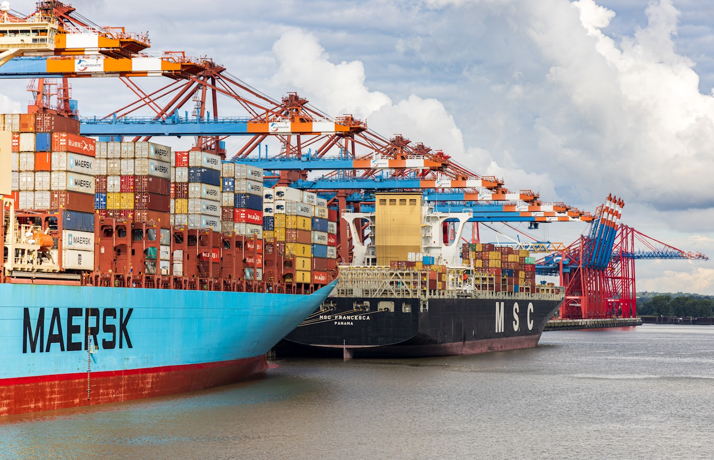 A cargo ship loaded with containers docked at a port